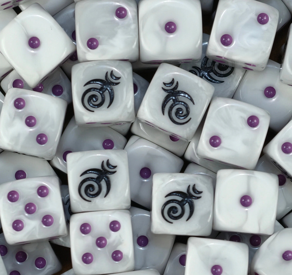 A pile of pearl white Slaanesh D6 with purple pips and black spirals