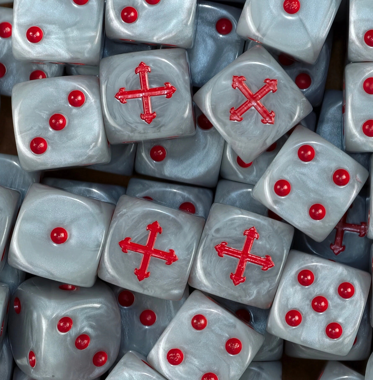 A pile of pearl white Badab War dice, red crosses and red pips repeating