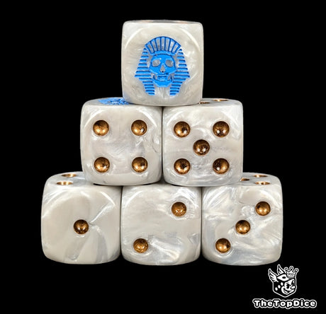 Close up of two bone white D6 with a blue pharaonic skull logo on the six face for fantasy football