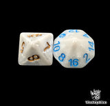 Close up of a bone white D8 and D16 with bronze numbers for scatter and long range rolls