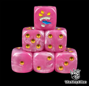 Pink 16mm D6 dice with a three eyed daemon face and gold pips for fantasy wargaming