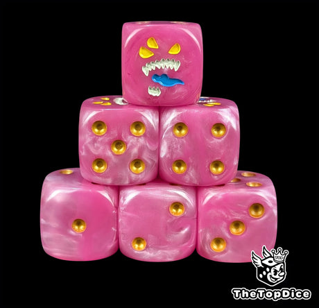 Pink 16mm D6 dice with a three eyed daemon face and gold pips for fantasy wargaming