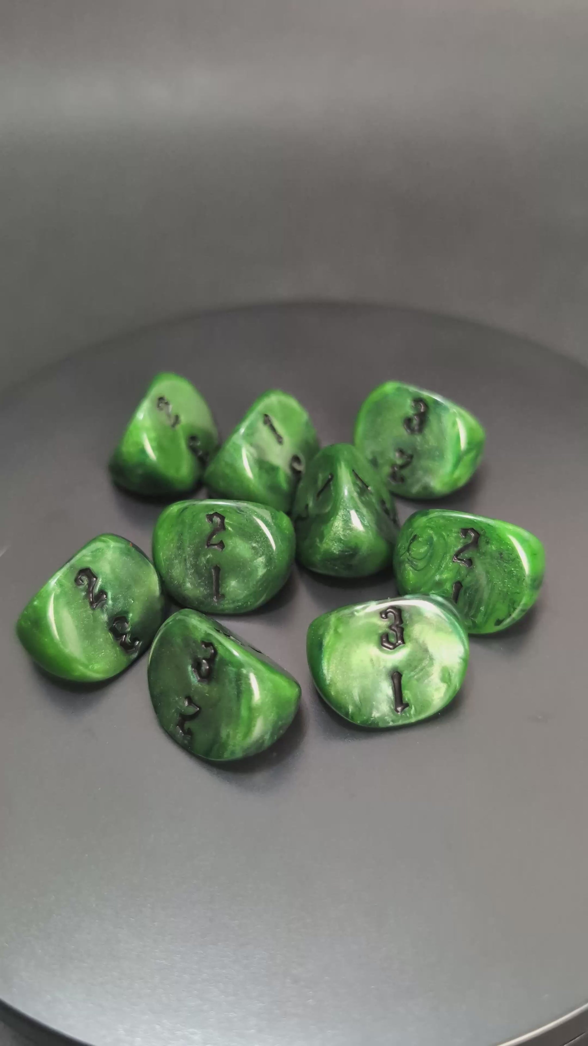 Green and black D3 resin dice with engraved numbers