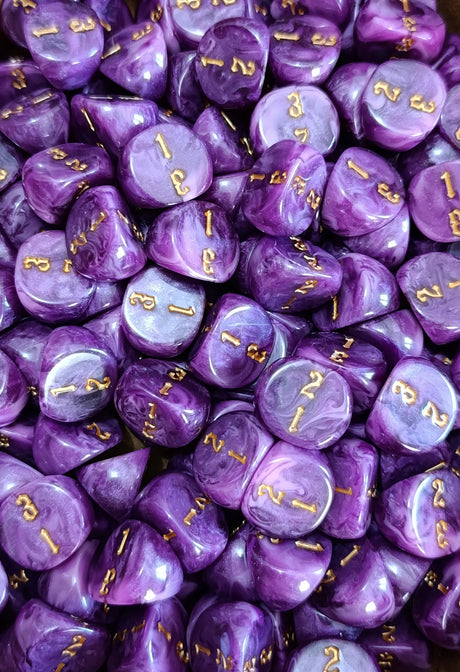 Pile of purple and pink D3 three sided dice for tabletop games