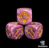 Close up of a purple and pink resin scatter die showing the gold direction arrows