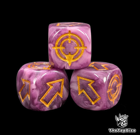 Close up of a purple and pink resin scatter die showing the gold direction arrows