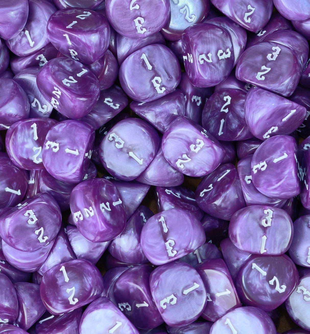 Tray packed edge to edge with violet and white three sided dice