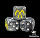Close-up of a black D6 die with two crossed yellow scythes