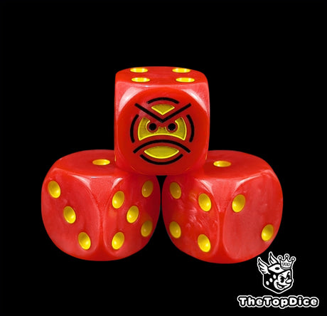 Close up of a red 16mm resin D6 die engraved with a yellow angry face and yellow pips
