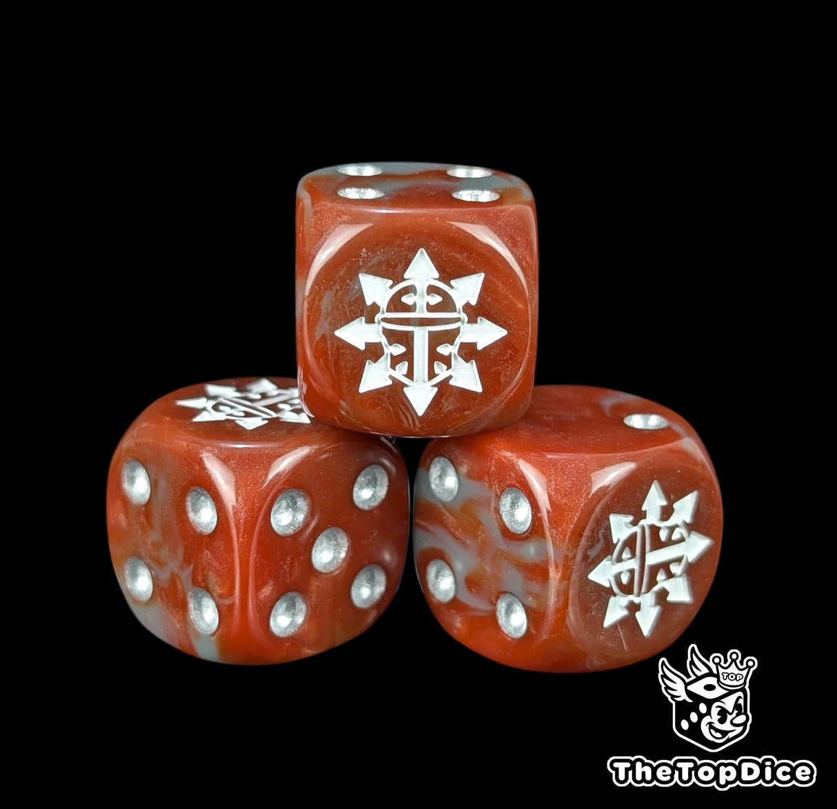 Close up of a red and grey 16mm resin D6 die engraved with a white spiked chaos helm and silver pips