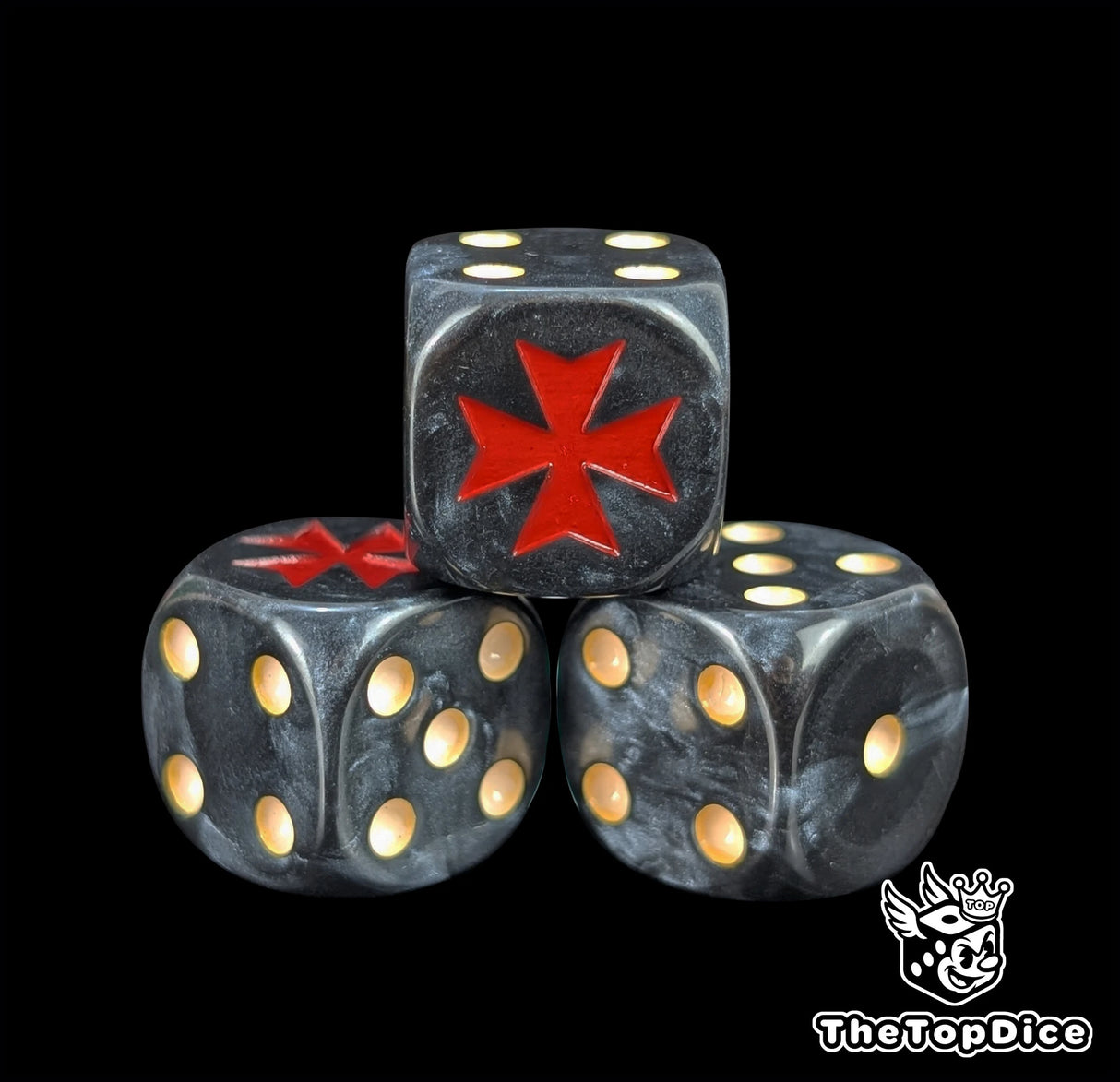 Close up of a black 16mm resin D6 die engraved with a red crusader cross and beige pips