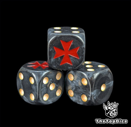 Close up of a black 16mm resin D6 die engraved with a red crusader cross and beige pips
