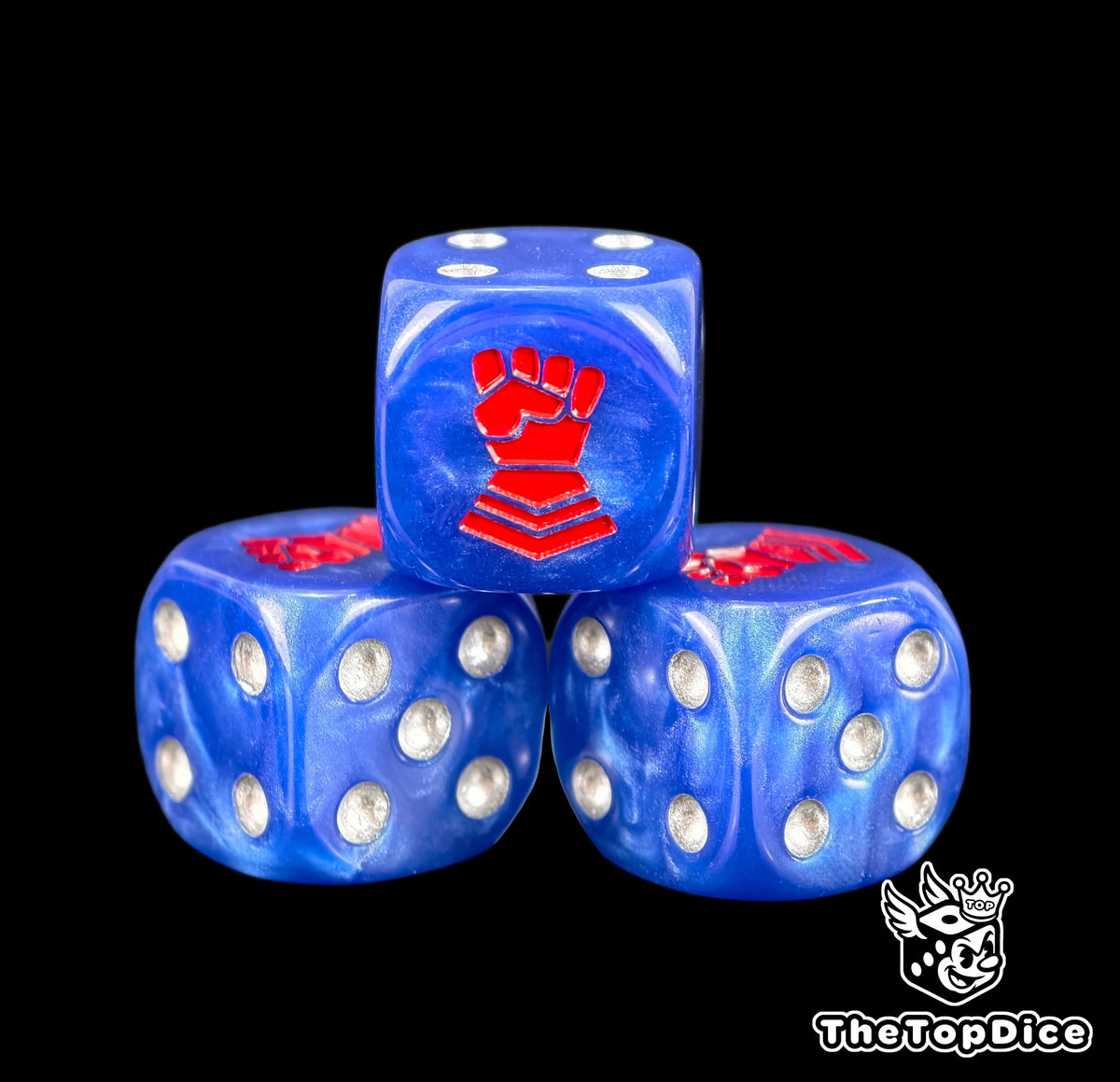 Three blue Crimson Fists dice with silver pips and a red fist