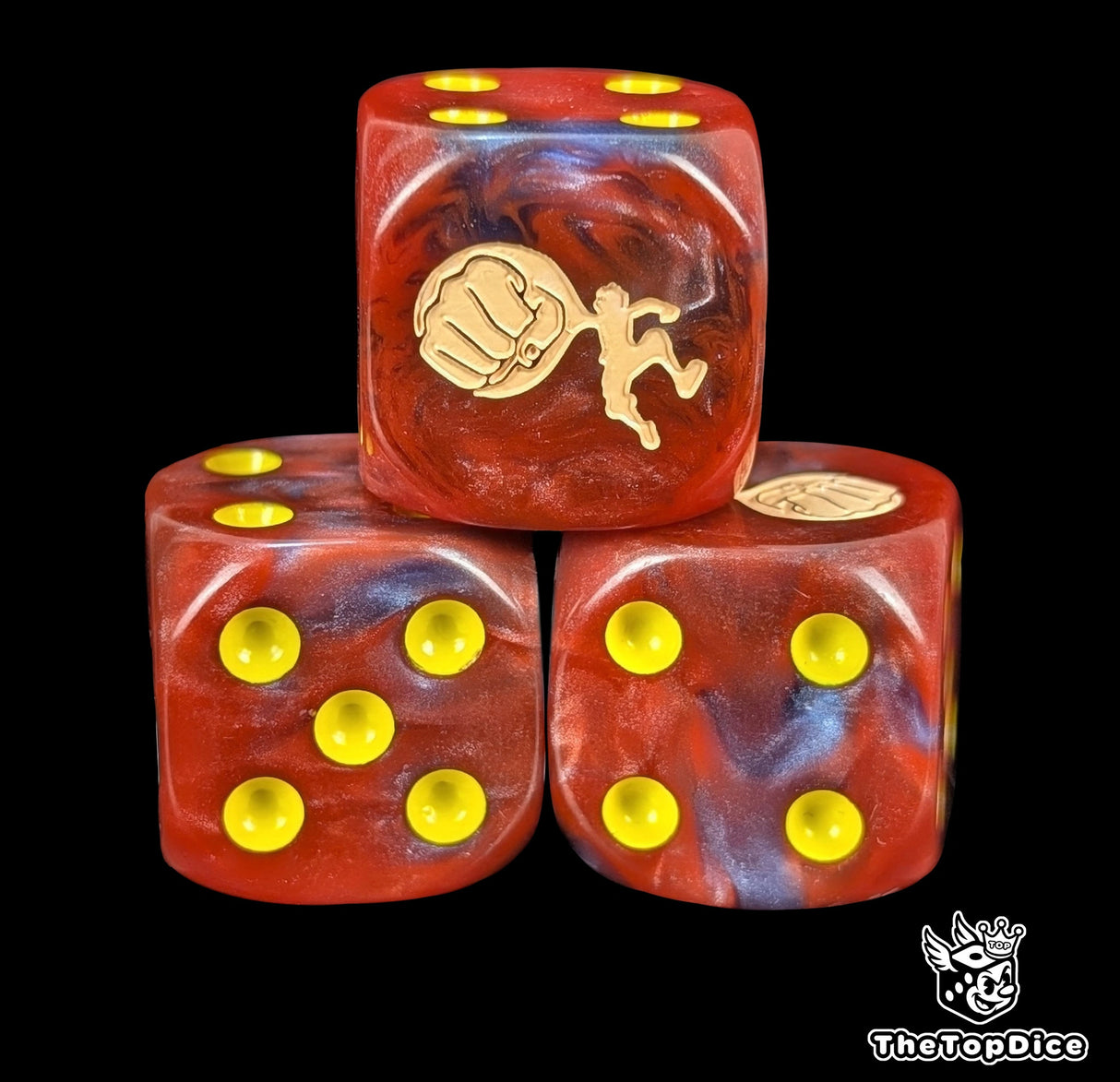 Close up of a red and blue 16mm resin D6 die engraved with a giant fist and yellow pips