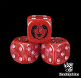 Close up of a red 16mm resin D6 die engraved with a black empress emblem and pink pips