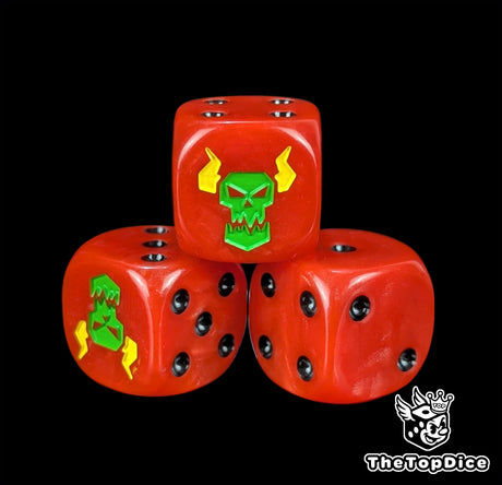 Close up of a red 16mm resin D6 die engraved with a green ork face and yellow lightning and black pips