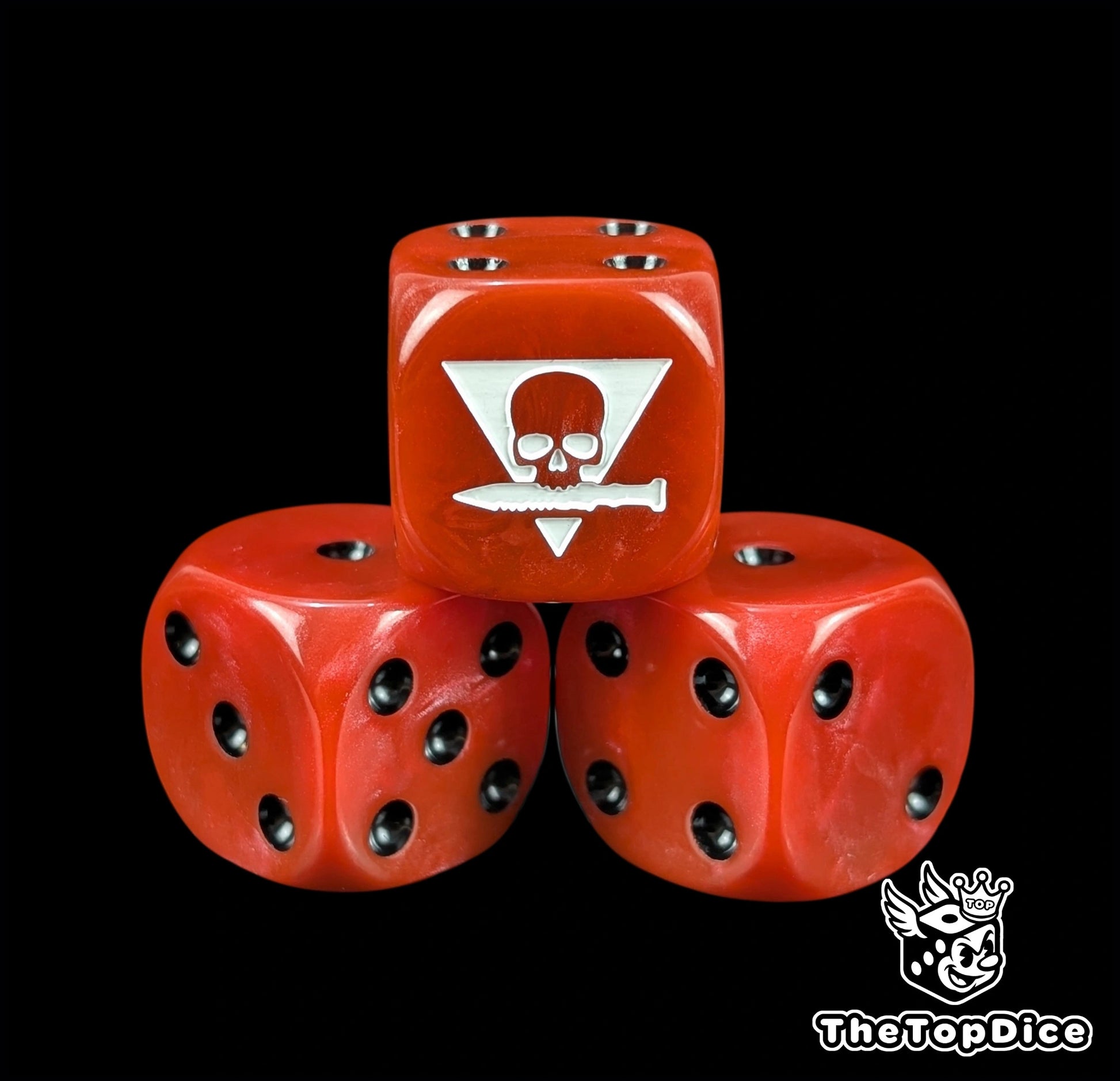Close up of a red 16mm resin D6 die engraved with a white squad sigil and black pips