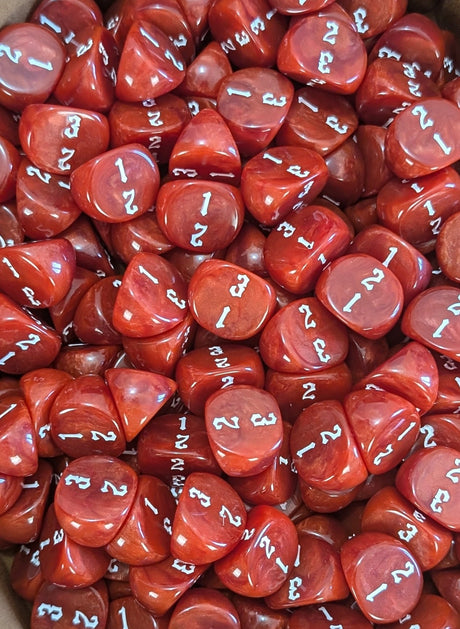 Pile of red D3 three sided dice for tabletop games