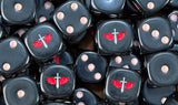 A pile of black Ravenwing dice, red winged swords and bone pips repeating