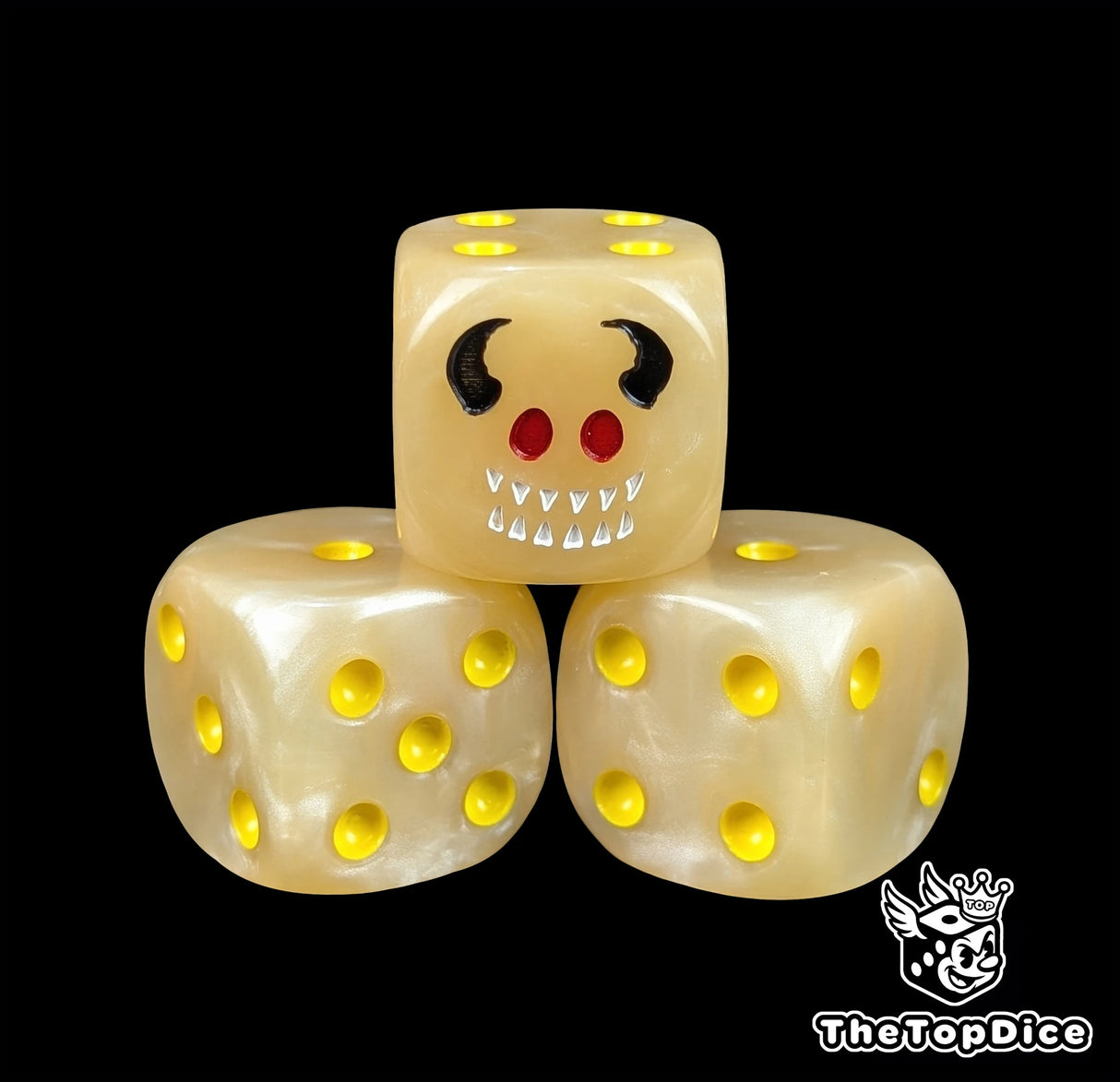 Close up of a flesh toned 16mm resin D6 die engraved with a horned imp face and yellow pips
