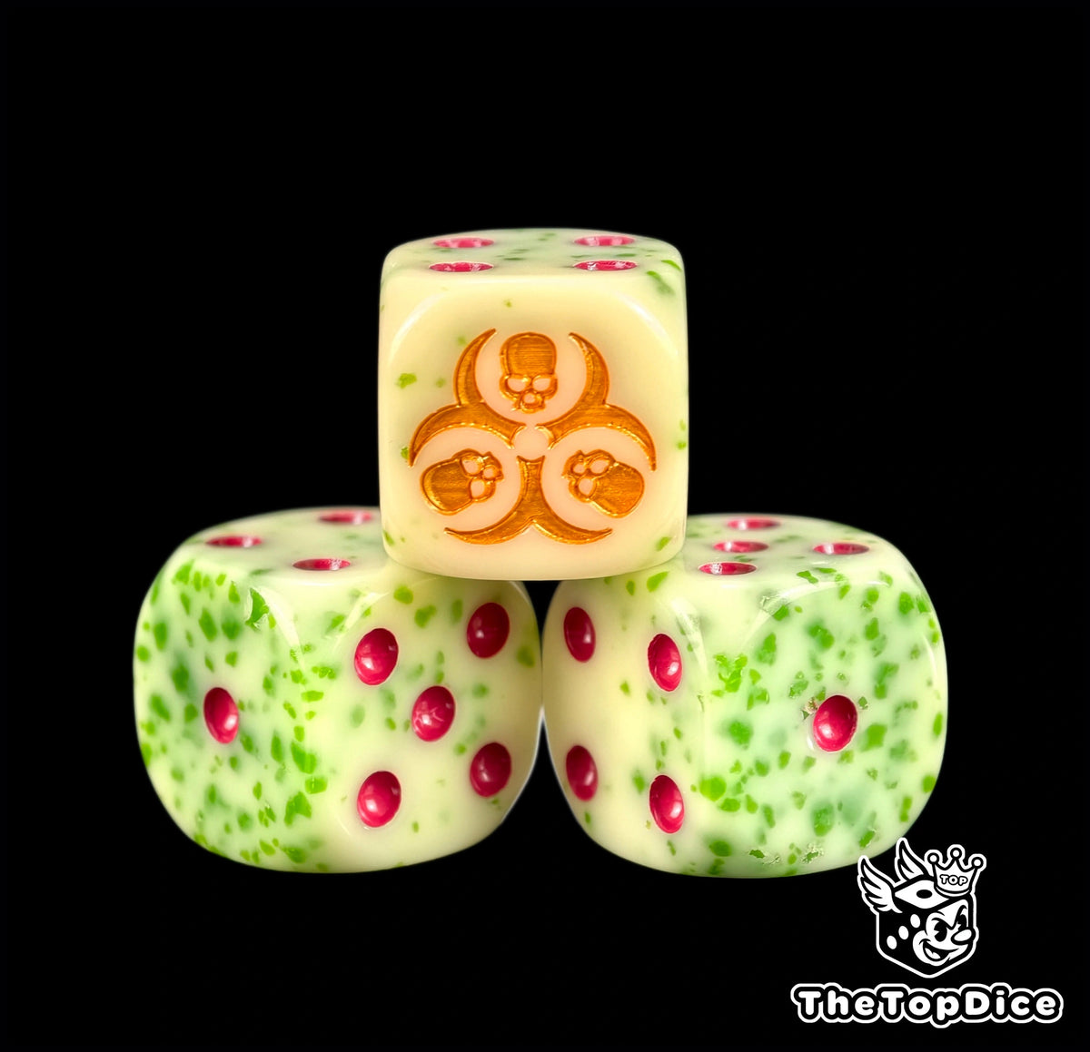 Three green flecked beige plague dice with a gold three skull ring