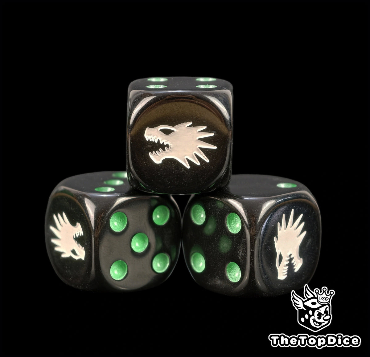 Close up of black Vulkan Salamanders dice with green pips and a white drake profile