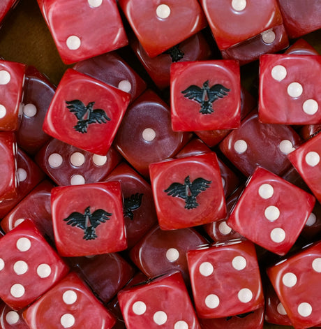 Pile of red Blood Ravens dice with white pips and black ravens
