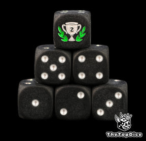 Second place trophy dice, matte black 16mm D6 with silver pips and a silver runner up cup in a green laurel, a tournament prize for board games and game nights