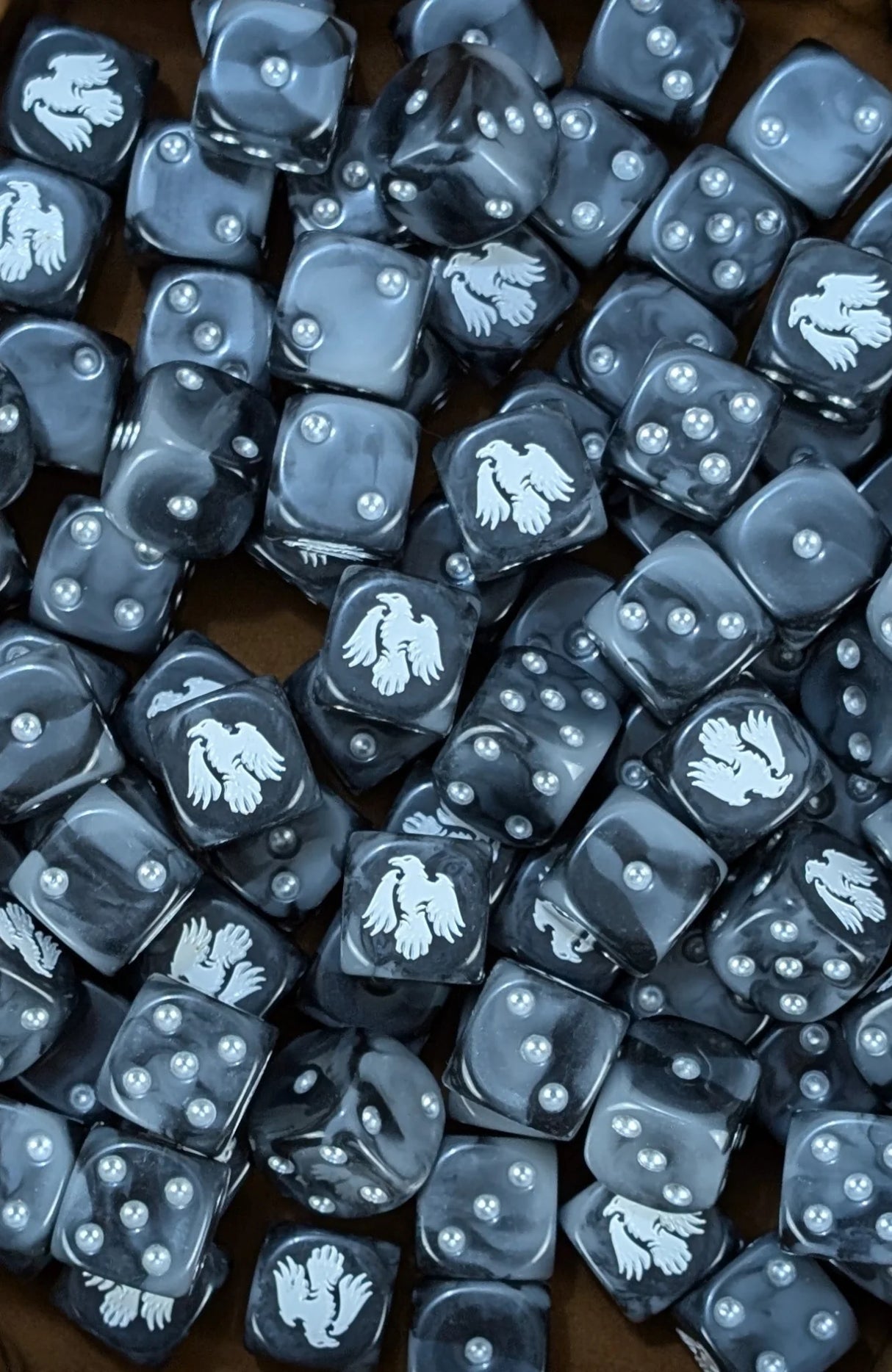 Pile of black and grey raven 16mm D6 dice for a sci-fi stealth army
