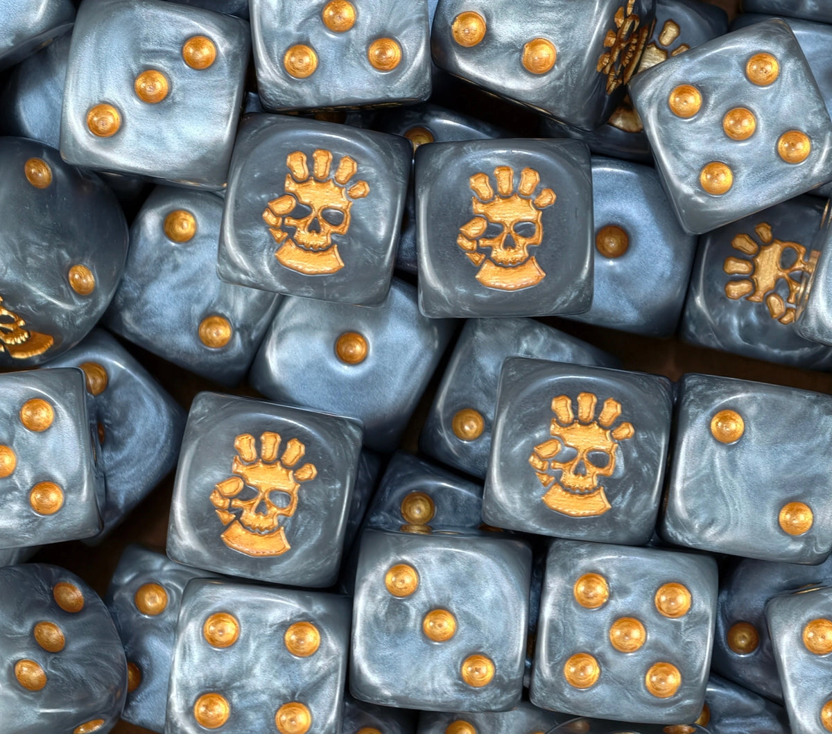 A pile of silver marine D6 with gold pips and gold fist skulls