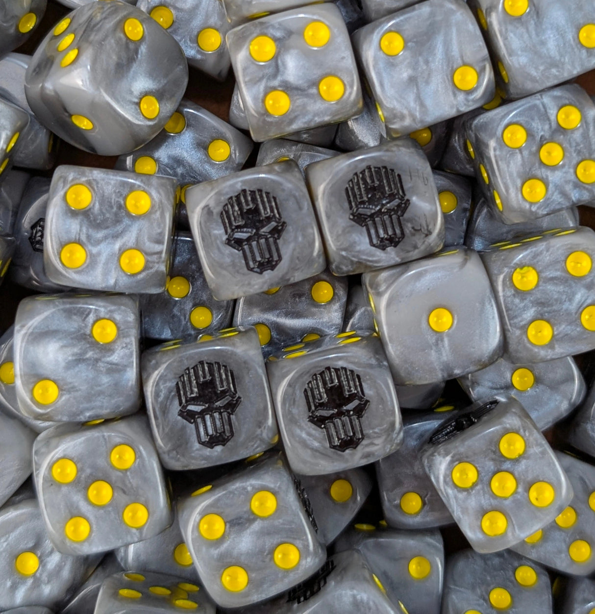 Pile of silver hazard skull 16mm D6 dice for a sci-fi chaos army