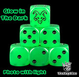 Skaven Age of Sigmar dice, translucent green glow in the dark 16mm resin D6 with black pips and a horned rat face, photographed with the lights on
