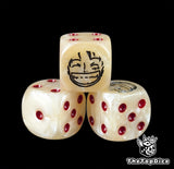 Close up of a beige 16mm resin D6 die engraved with a black smiling captain emblem and red pips