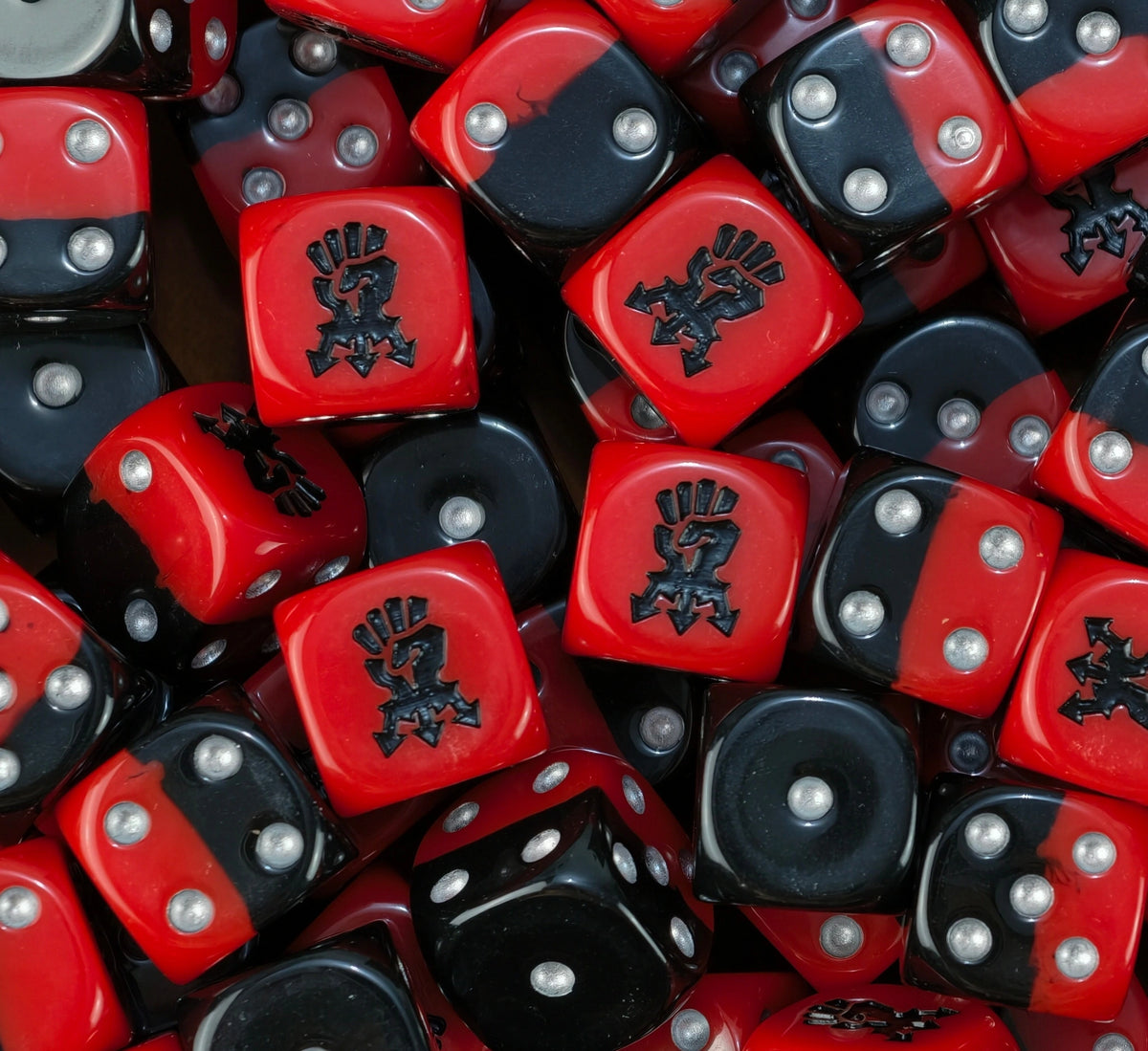 A pile of half red half black Red Corsairs D6 with silver pips
