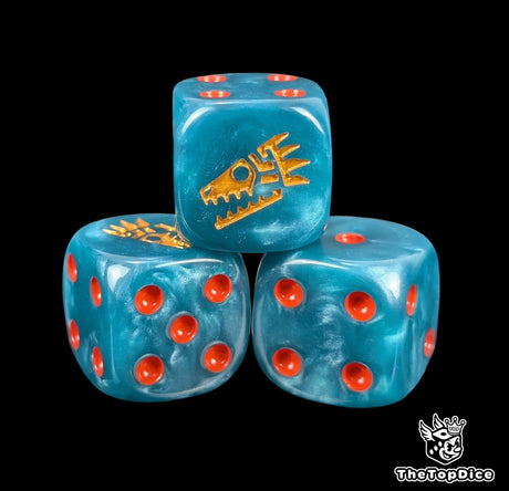 Close-up of three blue 16mm grimdark D6 dice engraved with a gold saurian face rune emblem