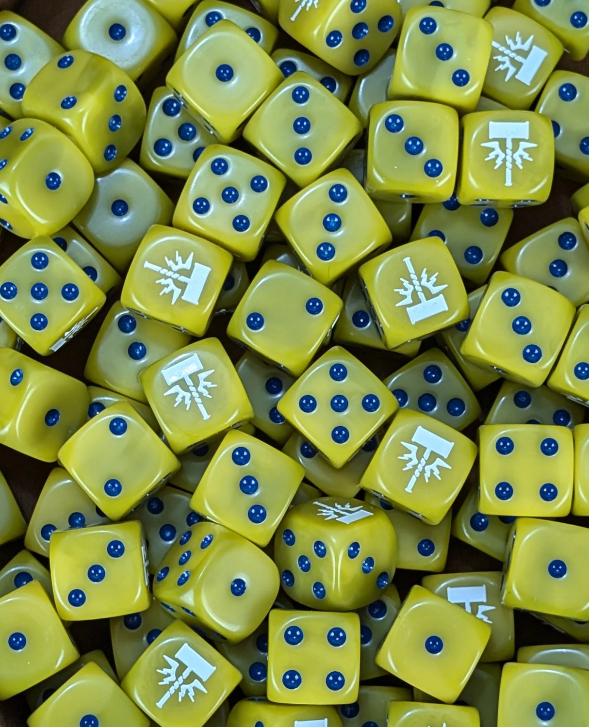 Pile of yellow storm hammer 16mm D6 dice for a fantasy celestial army