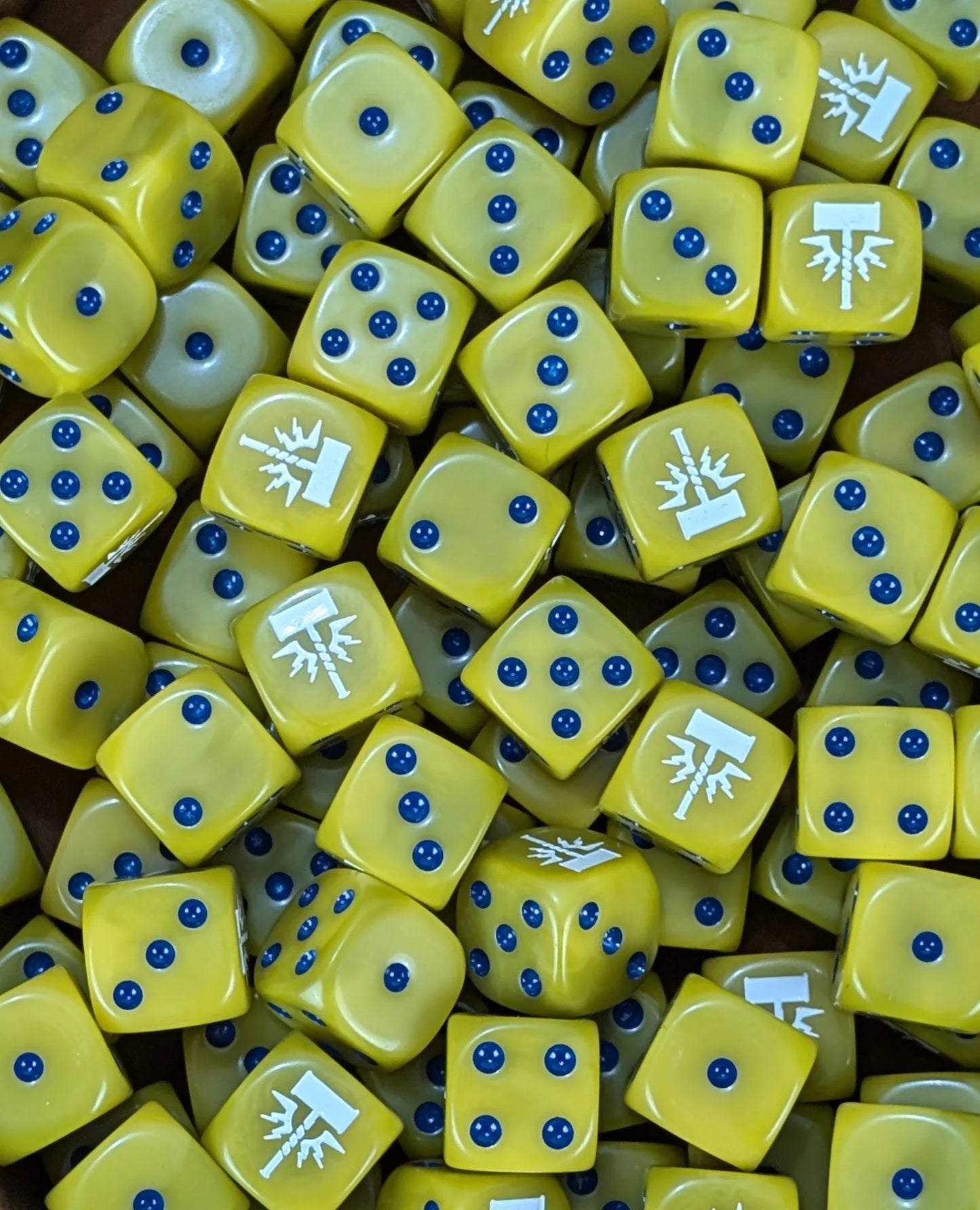 Pile of yellow storm hammer 16mm D6 dice for a fantasy celestial army