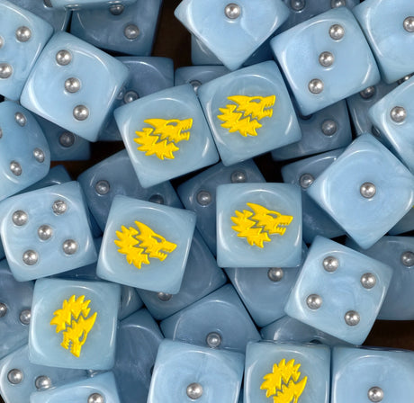 A pile of sky blue Space Wolves dice with silver pips and yellow wolves