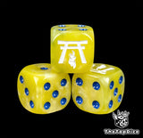 Close-up of a yellow D6 die with a white temple and flame