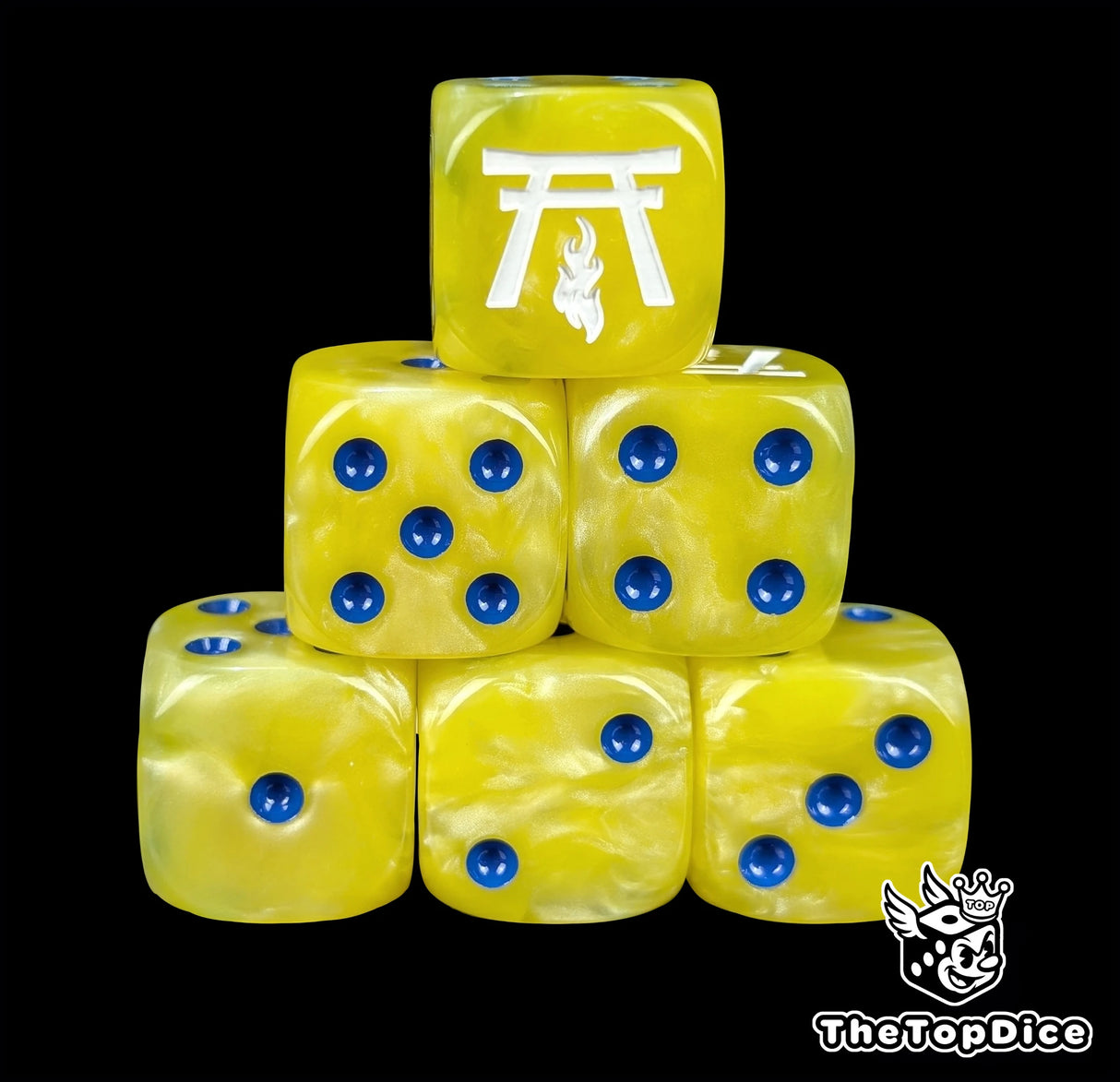 Yellow resin D6 dice with a white temple and flame and blue pips