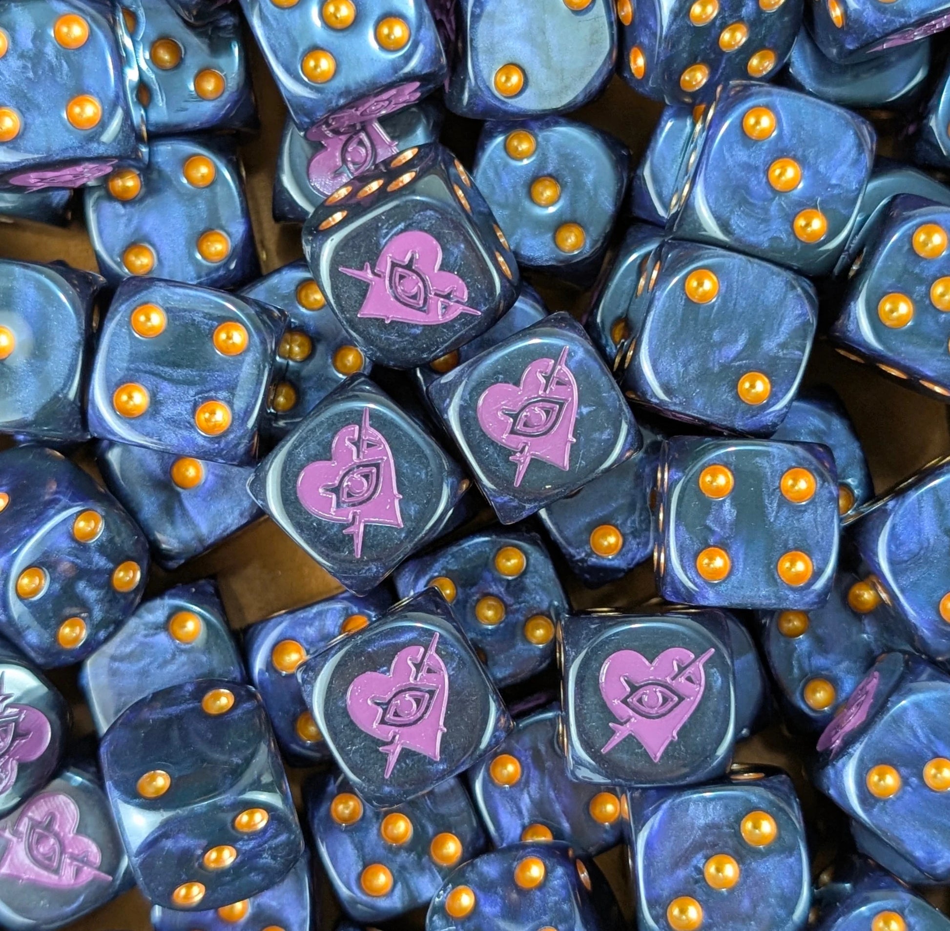 Pile of black and purple barbed heart 16mm D6 dice for a sci-fi raider army