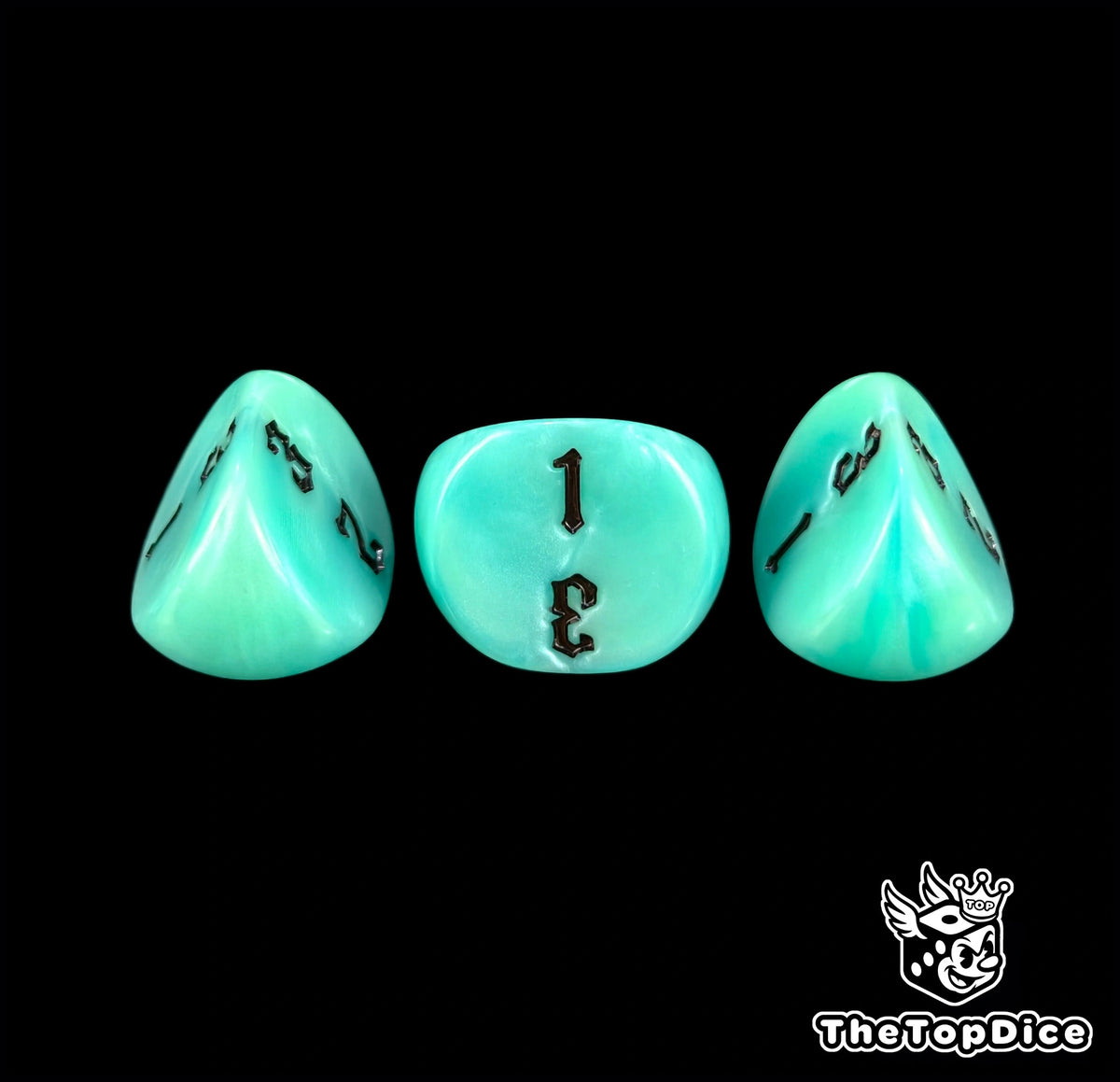 Detail of three turquoise 16mm three sided dice and their black engraving