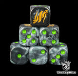 Black resin D6 dice with a gold twin serpent emblem and green pips