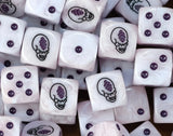 A pile of pale Genestealer dice with purple pips and a violet gem head