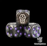 Close up of three purple Necron dice, black grey resin with a silver tomb glyph and purple pips