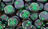 A pile of black Skaven dice, green runes and green pips repeating