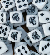 A pile of white Harlequin D6 with black diamond shaped pips