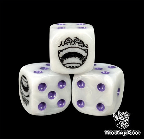 Close up of a white 16mm resin D6 die engraved with a black grinning emblem and purple pips