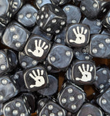 Pile of black white hand orc 16mm D6 dice for a dark fantasy miniature army