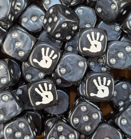 Pile of black white hand orc 16mm D6 dice for a dark fantasy miniature army